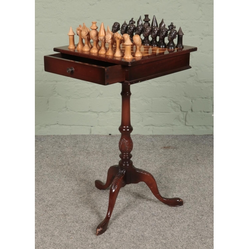 419 - A mahogany chess table, on turned central pillar supported by carved tripod base. With double sided ... 