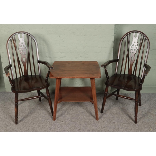 423 - A pair of wheelback armchairs along with a two tier side table.