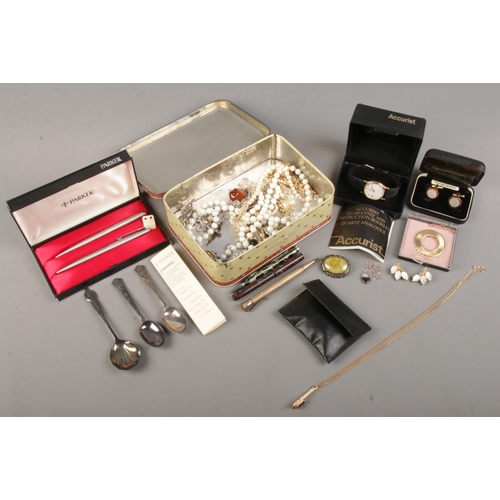 20 - A tin of costume jewellery and pens. Includes 14ct gold nib fountain pen, cased Parker two pen set, ... 