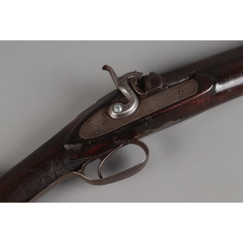 45 - A late 19th century percussion cap rifle. Having 82cm cylindrical barrel and chequered walnut stock.... 