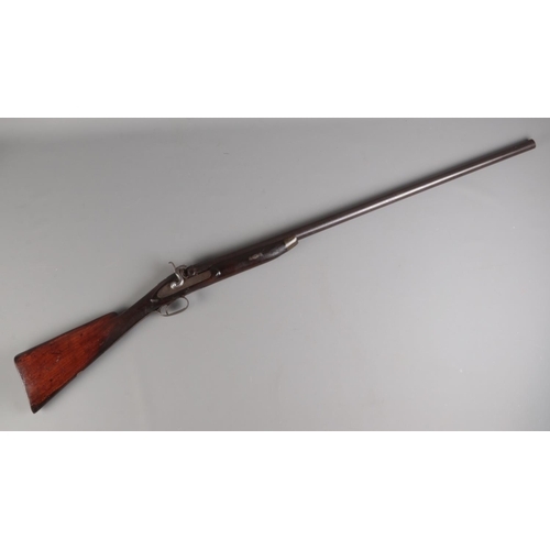 45 - A late 19th century percussion cap rifle. Having 82cm cylindrical barrel and chequered walnut stock.... 