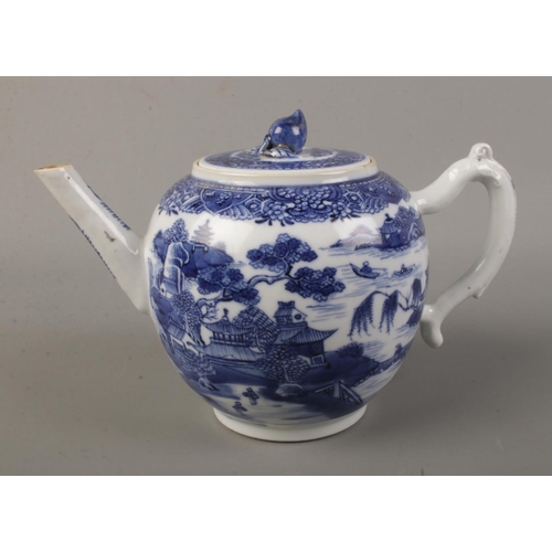 359 - A 19th century bullet shape teapot with blue and white transfer print and lotus flower bud finial. H... 