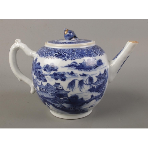 359 - A 19th century bullet shape teapot with blue and white transfer print and lotus flower bud finial. H... 