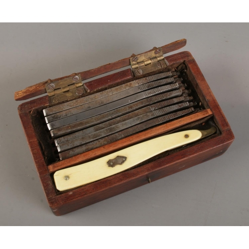 375 - A wooden cased cut throat razor set consisting of ivorine handle and seven John Ledger blades.