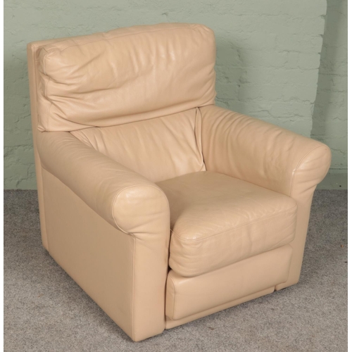 386 - A cream leather armchair.