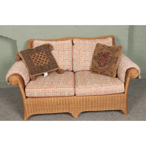 388 - A four piece rattan conservatory suite. Comprising of a pair of two seat sofas and two armchairs.