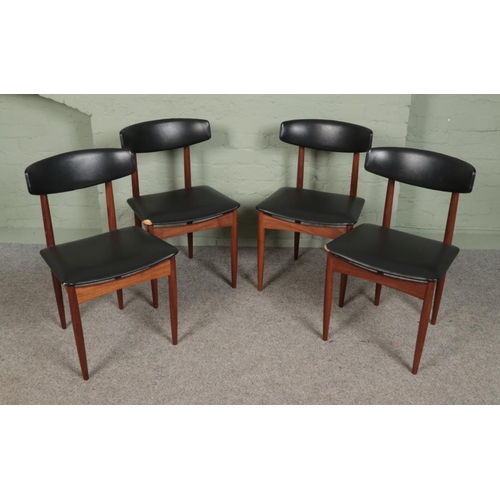 392 - A set of four teak chairs with black leather upholstery.