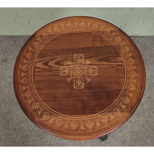 394 - A cast iron tavern table with decorative patterned oak top. Height: 70cm, Diameter of top: 60cm.