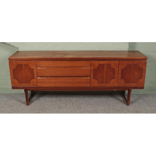 398 - A teak side board with three cupboard doors and three doors. 

Hx73cm
Wx184cm
Dx45cm