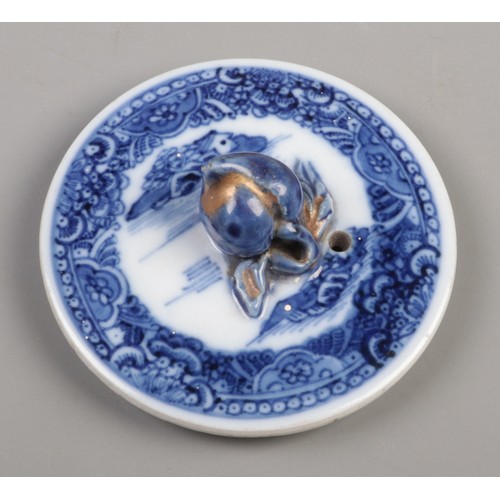 359 - A 19th century bullet shape teapot with blue and white transfer print and lotus flower bud finial. H... 