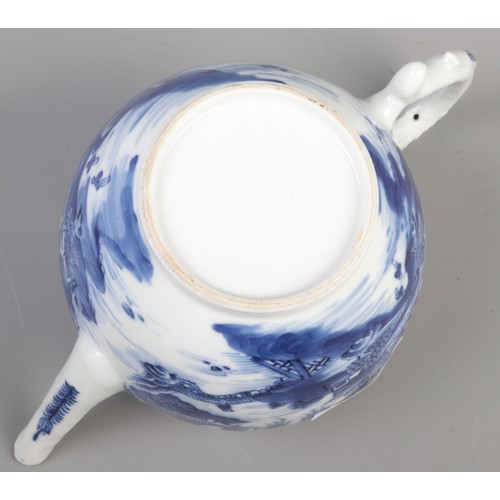 359 - A 19th century bullet shape teapot with blue and white transfer print and lotus flower bud finial. H... 