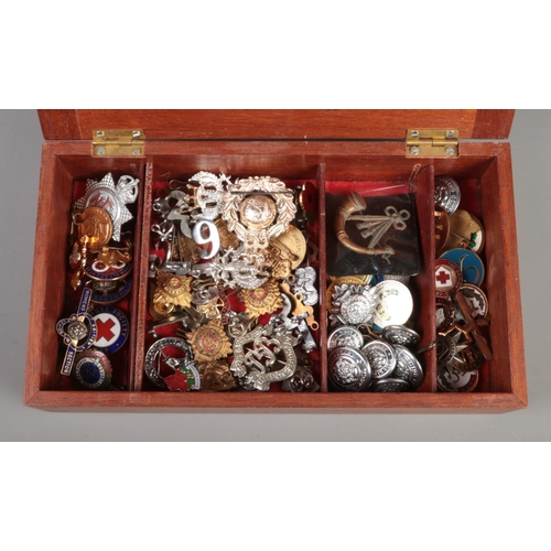 59 - A collection of mixed costume jewellery, charms and accessories. To include a quantity of military c... 