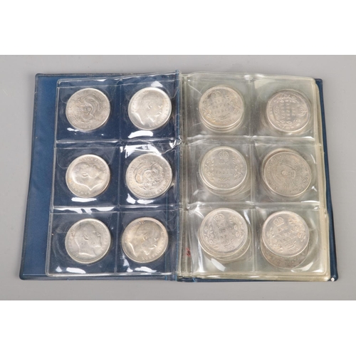 80 - A folder of white metal reproduction world coins including China, India and the US along with small ... 