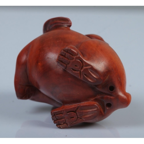 335 - A Japanese carved Netsuke in the form of a rabbit with ruyi.