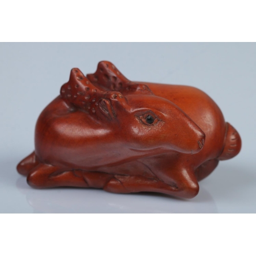 336 - A Japanese carved Netsuke in the form of a resting deer