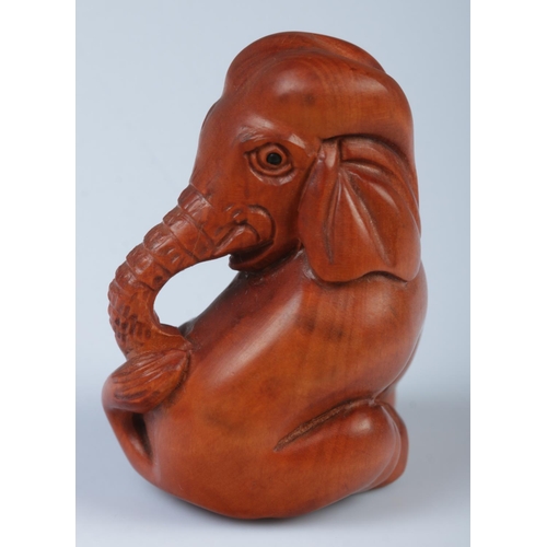 339 - A Japanese carved Netsuke in the form of a elephant.