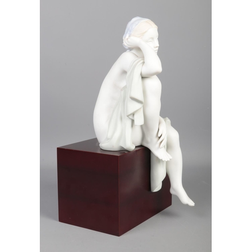 344 - A Limited Edition Lladro figure; 'Lost in Thought', raised on wooden base. No. 215/1500. With detail... 