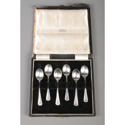 354 - A cased set of six silver coffee spoons, with floral handles. Assayed for London, 1938 by Enid Kelse... 