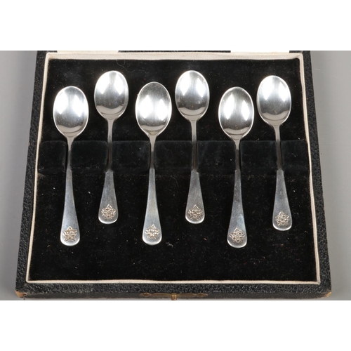 354 - A cased set of six silver coffee spoons, with floral handles. Assayed for London, 1938 by Enid Kelse... 