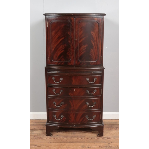 365 - A bow fronted mahogany drinks cabinet, with cupboard doors, pull-out shelf and fake drawers to the b... 