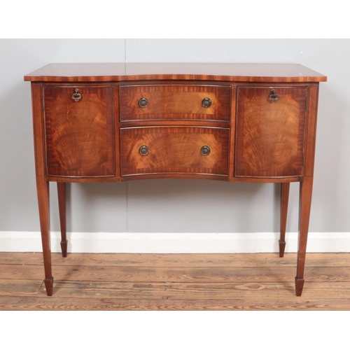 366 - A serpentine mahogany sideboard with two doors and two drawers on square tapering legs.

Hx88cm
Wx10... 