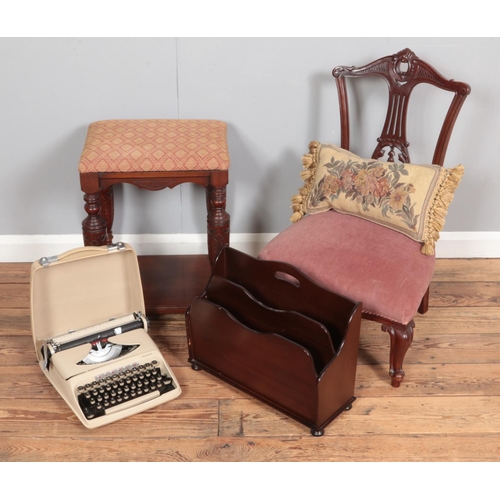 370 - A heavily carved nursing chair together with an upholstered stool, magazine rack and student typewri... 