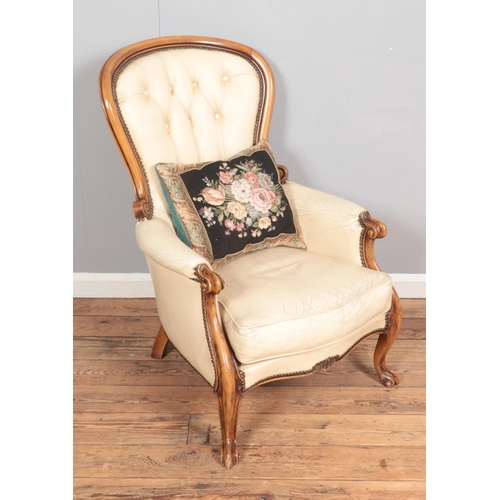 374 - A walnut spoon back chair with cream leather upholstery and deep button back