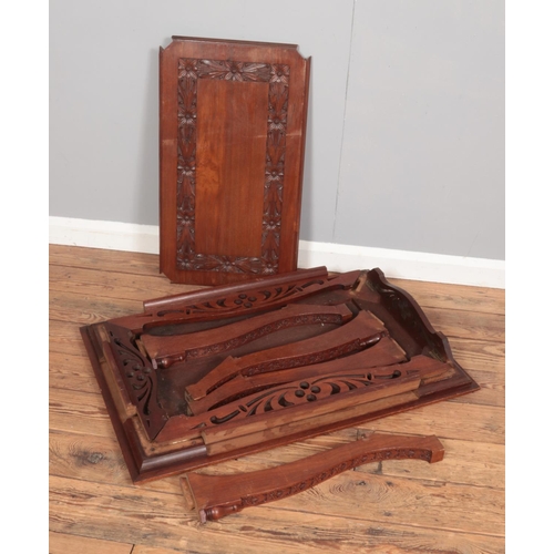 385 - A carved oak two tier side table with floral decoration. (65cm x 92cm x 62cm)