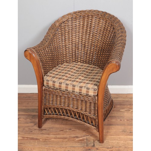 375 - A quality wicker armchair with padded seat.