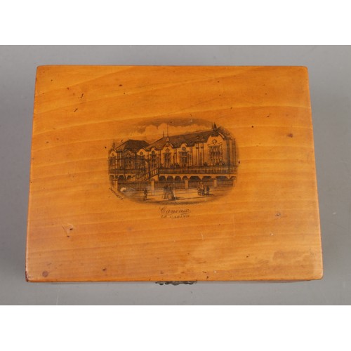 358 - A Mauchline pocket watch box, with scene of 'Cayeux Le Casino' to the front, inside containing two g... 