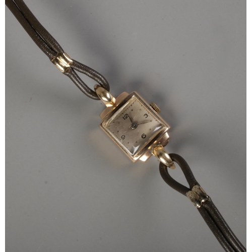 349 - A ladies 9ct gold cased cocktail watch on leather strap.