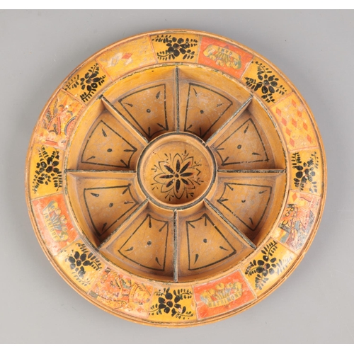 68 - A wooden Pope Joan staking board with painted and applied decoration. Diameter 29cm.