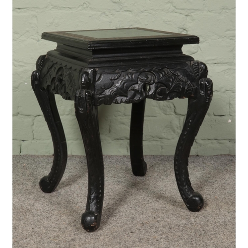 480 - An Oriental lacquered jardiniere stand with Greek Key border, carved detailing and cabriole feet.