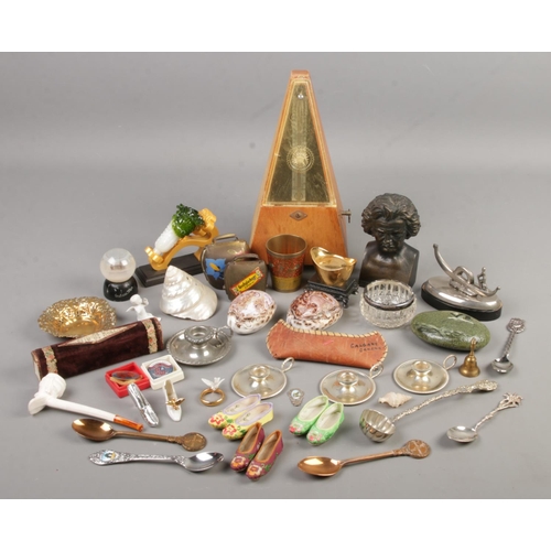 119 - A box of collectables. Includes silver rim jar, metronome, oriental shells, souvenir spoons, gilt di... 