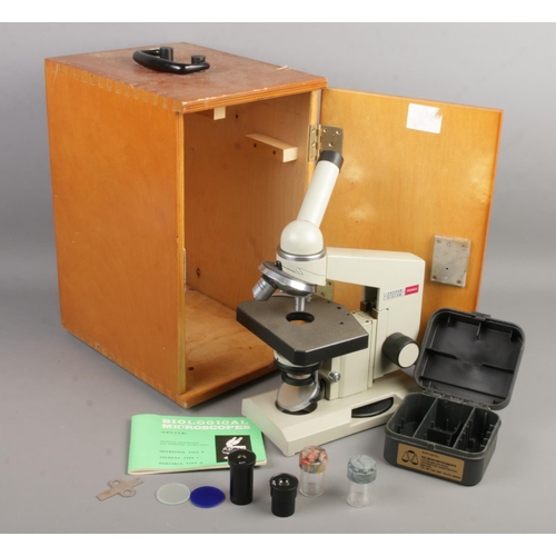 125 - A cased Russian Nomo Biological microscope with accessories.