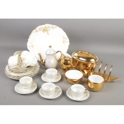 128 - A collection of bone china. Includes Royal Worcester gilt teawares, Czechoslovakian lustre coffee se... 