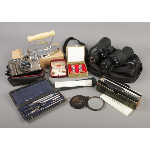 132 - A box of collectables. Includes tortoiseshell pocket mirror, Tasco binoculars, cased cloisonne boots... 