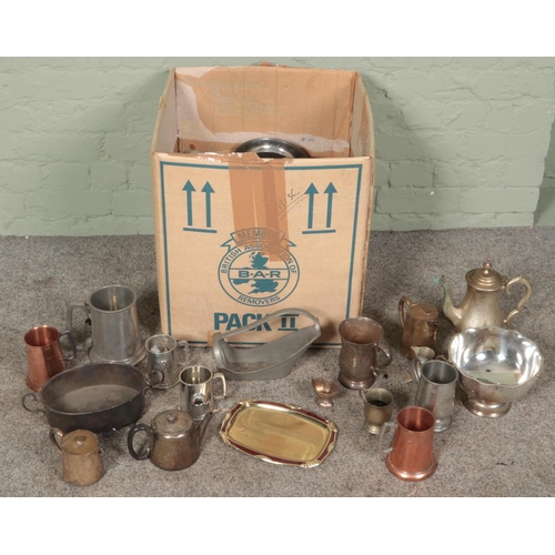 182 - A large box of metalwares. Includes pedestal bowl, teapots, wine holder, tankards, etc.