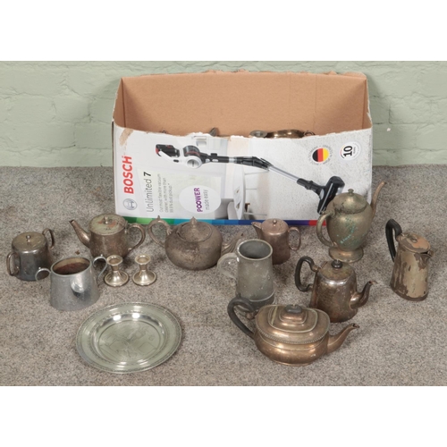 192 - A box of metalwares. Includes teapots, dwarf candlesticks, sugars bowls, toast rack, etc.