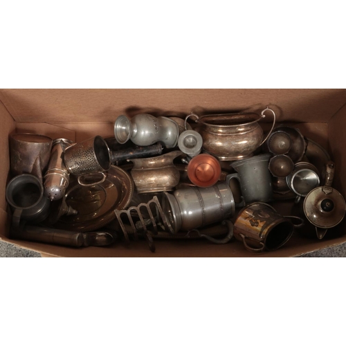 192 - A box of metalwares. Includes teapots, dwarf candlesticks, sugars bowls, toast rack, etc.