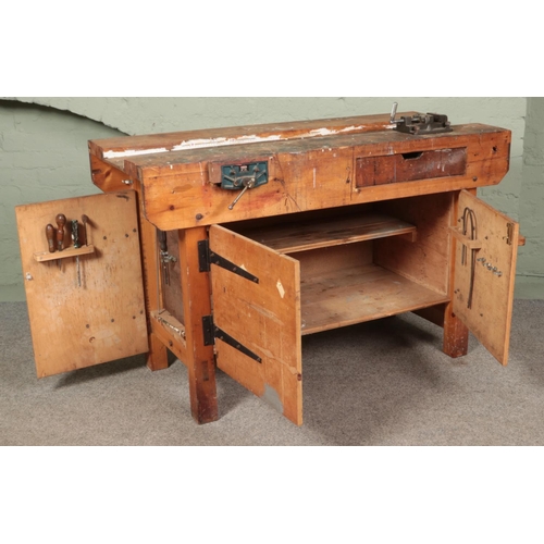 265 - A work bench with cupboard base and Paramo vice. (87cm x 138cm x 61cm)