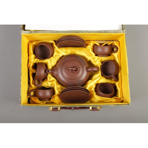 59 - A mid Twentieth Japanese child's tea service in box, together with a hinged travelling case.