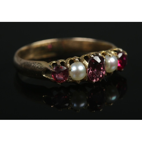 353 - A 9ct Gold five stone ring, featuring ruby coloured stones. Size J½. Total weight: 1.8g.