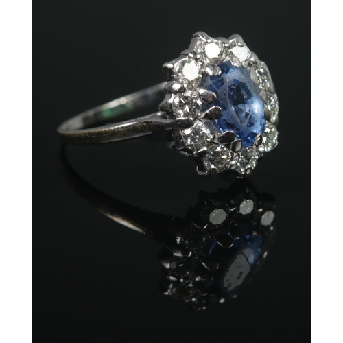 356 - An 18ct White Gold, Sapphire and Diamond cluster ring, with central stone surrounded by ten diamonds... 