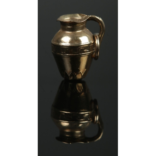 375 - A 9ct Gold charm, formed as a water pitcher jug. Stamped to the side of the jug. Total weight: 0.8g.