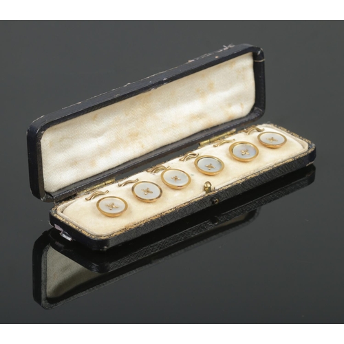 385 - A cased set of six 9ct Gold and Mother of Pearl buttons, in fitted case. Stamped 9ct and GAF to the ... 