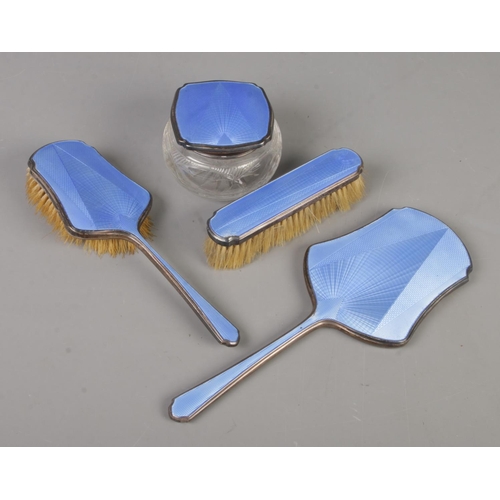 431 - An Art Deco four part silver and guilloche enamel dressing table set. Includes two brushes, hand mir... 