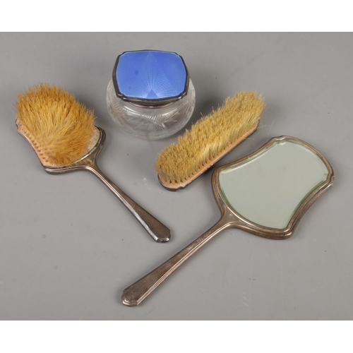 431 - An Art Deco four part silver and guilloche enamel dressing table set. Includes two brushes, hand mir... 