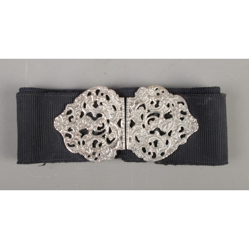 441 - A vintage nurses belt with silver pierced buckle. Assayed for London 1961.