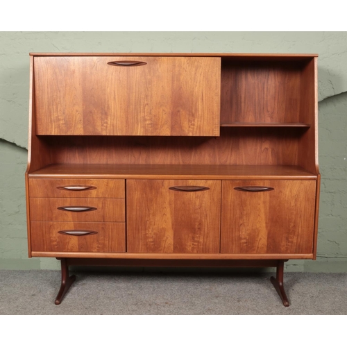 457 - A vintage teak AustinSuite highboard. Having drop down cupboard top and drawer and cupboard base.